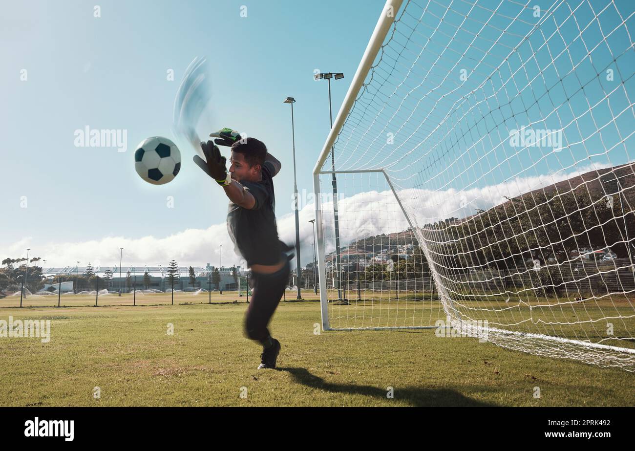 Goalkeeper, soccer and man jumping for the ball to save the goals by