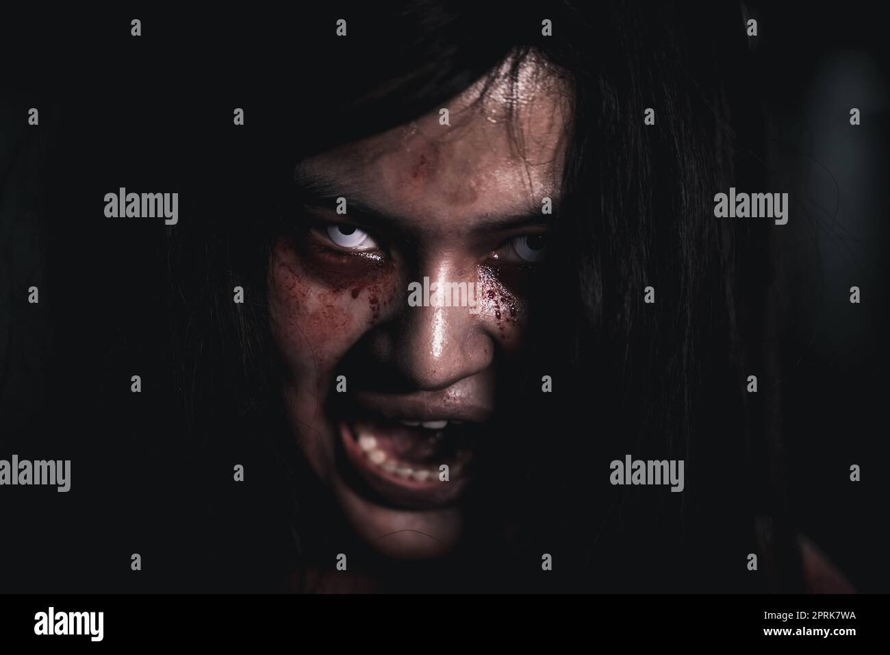 Horror bloodthirsty woman ghost or zombie she is horror scary with open mouth at dark night, Screaming zombie female face with blood, Happy halloween Stock Photo