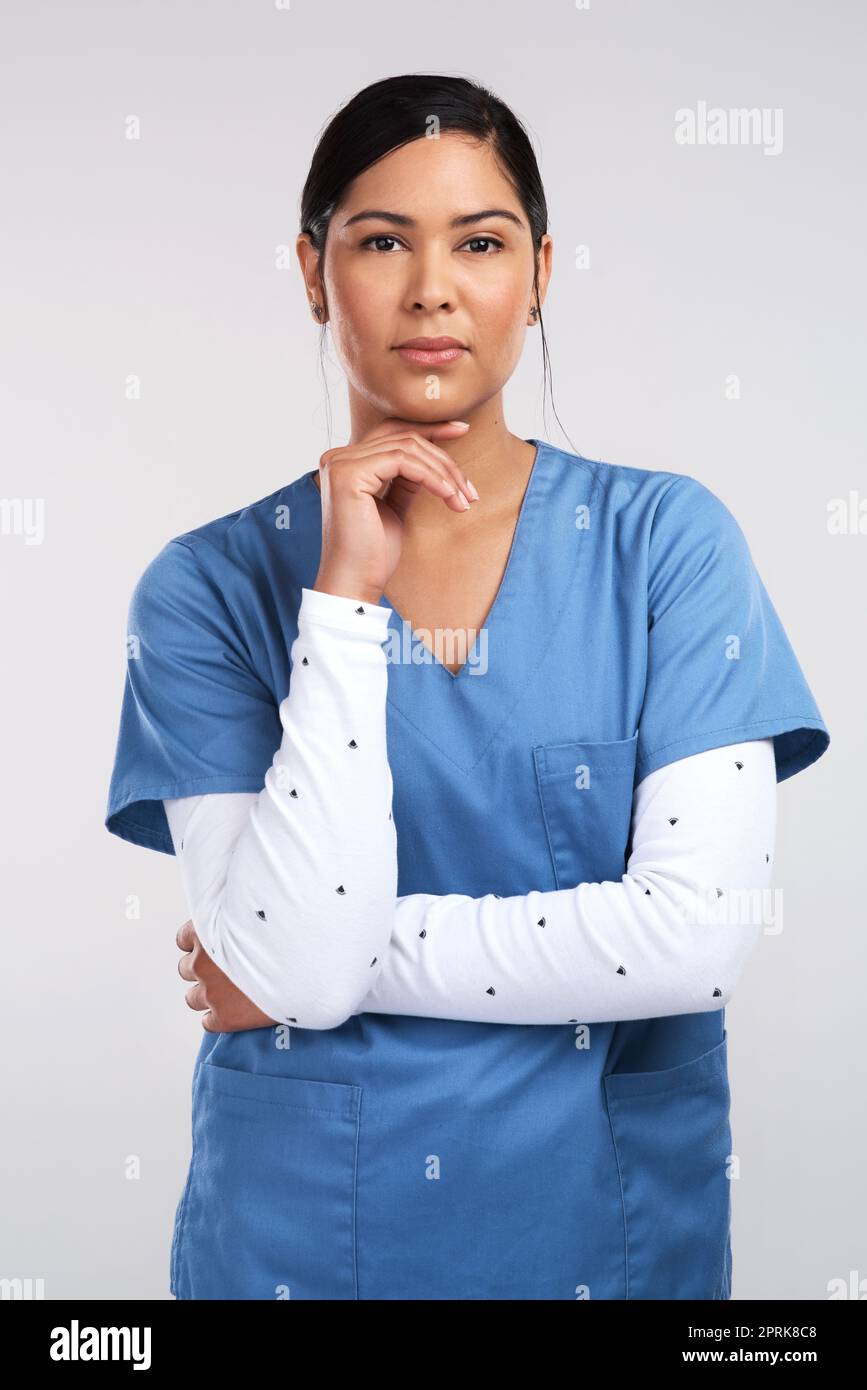 Youre my wanderer, little wanderer..Wouldya wander back to me. Portrait of a young beautiful doctor in scrubs against a white background Stock Photo