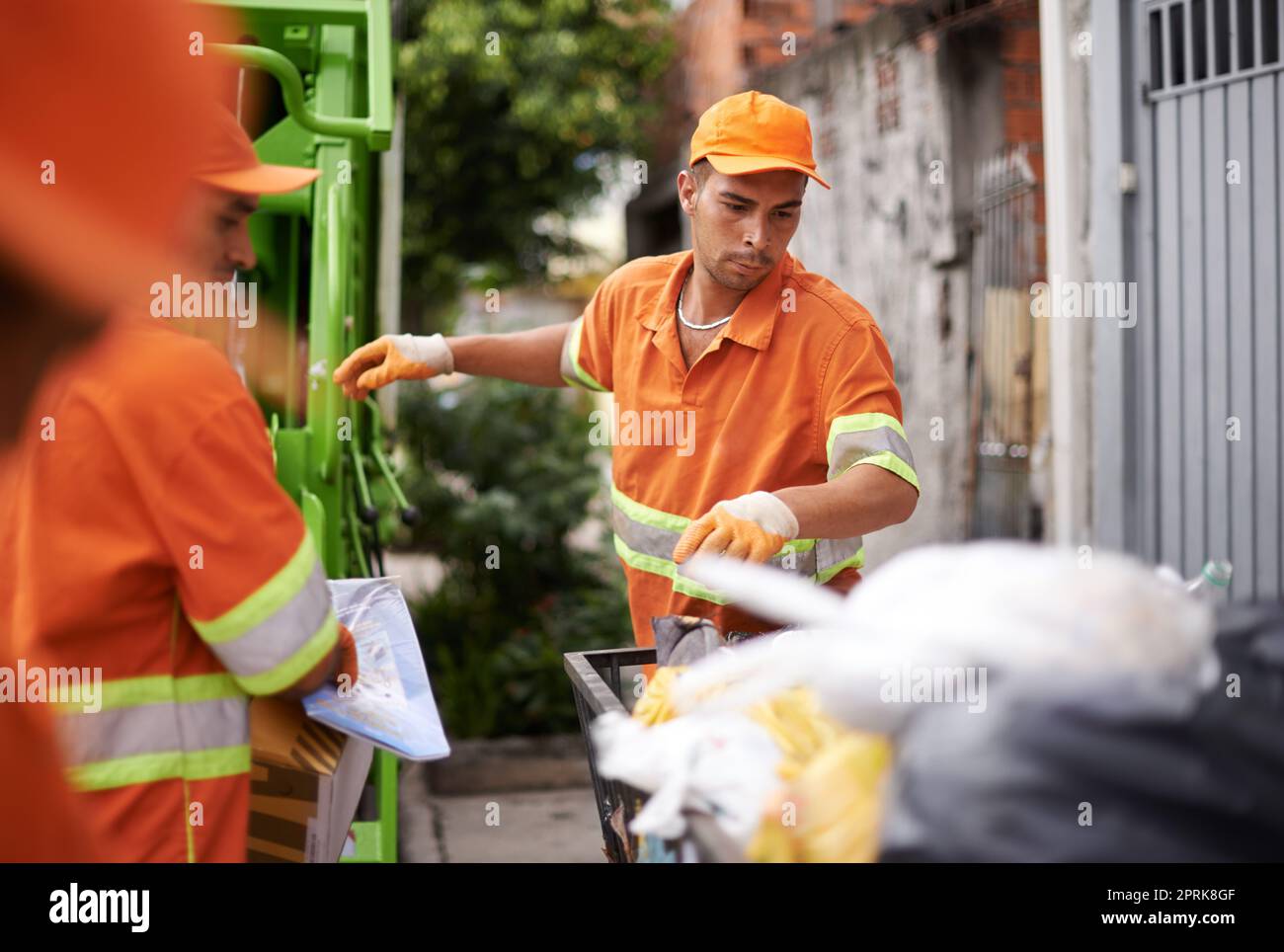 Garbage collection day. a garbage collection team at work Stock Photo