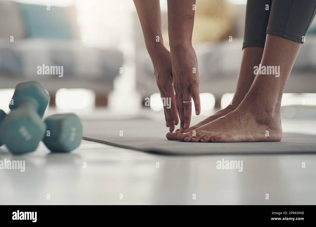 Premium Photo  Closeup of a girl stretching to touch her toes while  sitting on a yoga mat