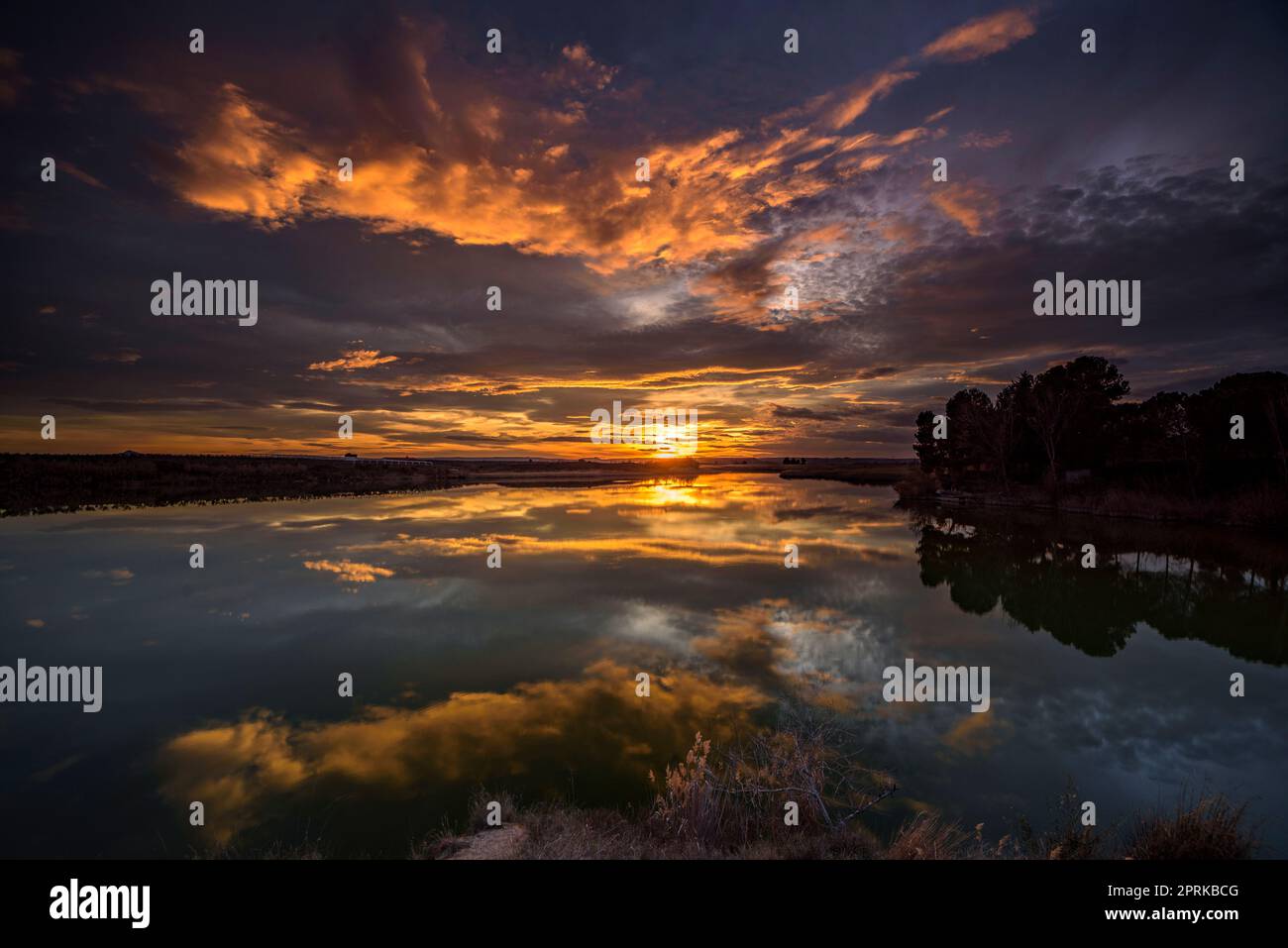 Sunset with a red sky in the Utxesa reservoir in Torres de Segre (Segrià, Lleida, Catalonia, Spain) ESP: Atardecer con cielo rojizo en Utxesa Stock Photo