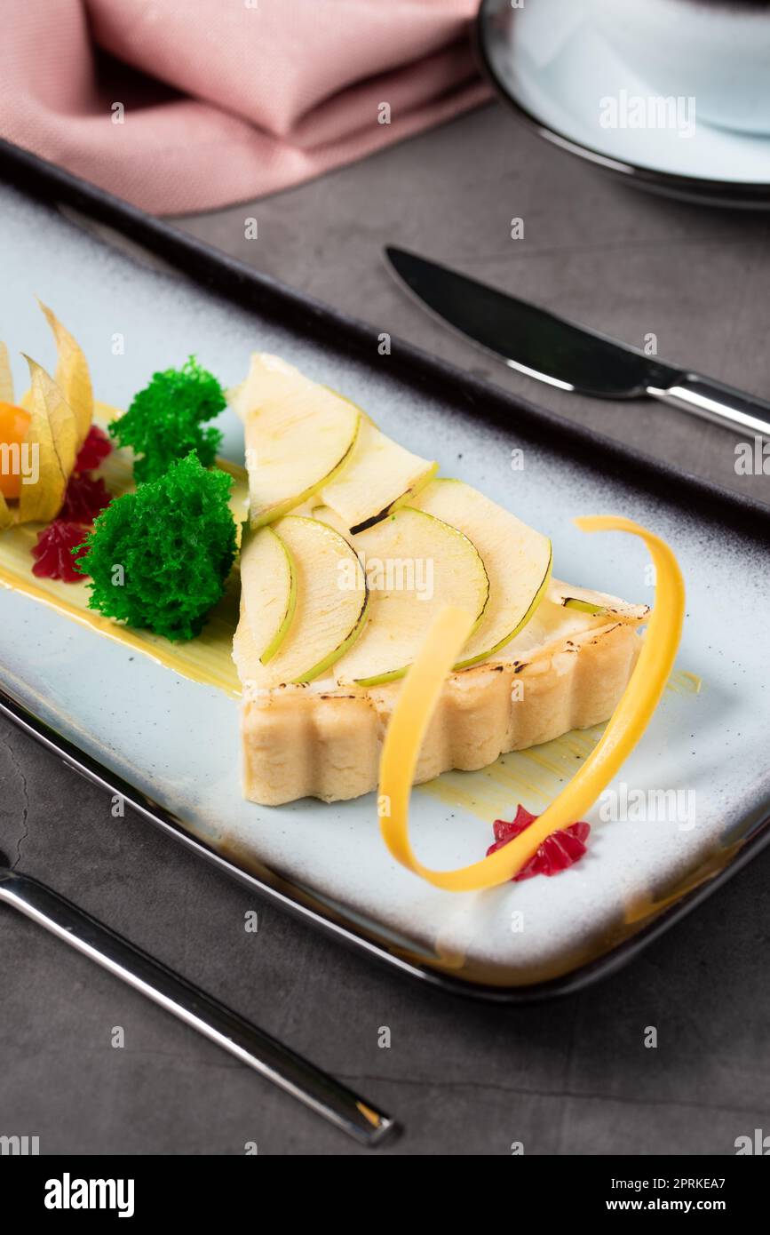 Apple tart on stone table in fine dining restaurant Stock Photo