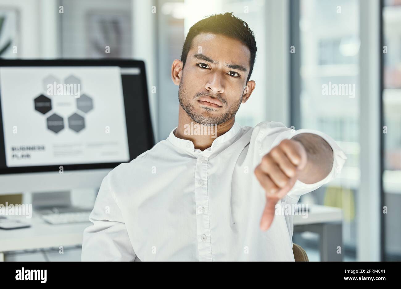 Im honestly not impressed. a businessman showing thumbs down while