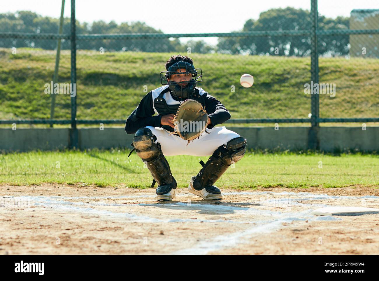 Hes got it. Full length shot of a handsome young baseball player catching a ball during a game on the field Stock Photo