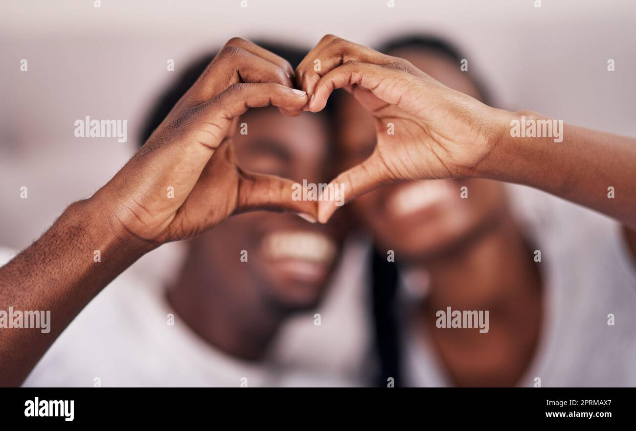 Royalty-Free photo: Couple's hands forming heart gesture