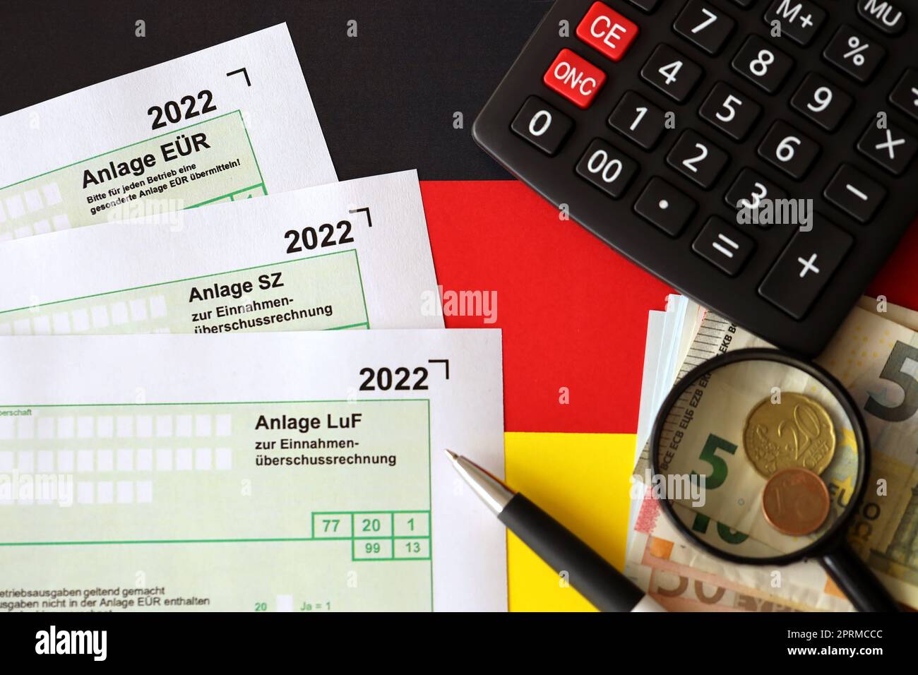 German different tax declaration blank forms - Anlage EUR, Anlage SZ and Anlage Luf. Documents lies with calculator, pen and european money bills Stock Photo