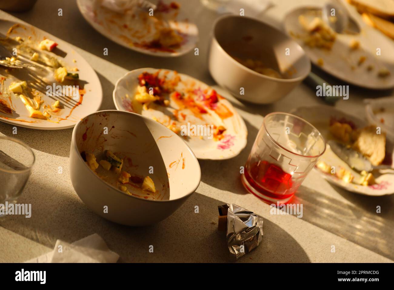 Empty dirty plates with spoons and forks on the table after meal