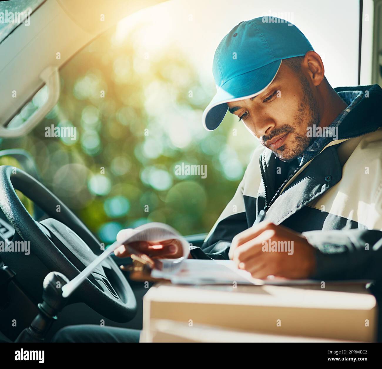 Where to with the next delivery. a courier making deliveries in his van. Stock Photo