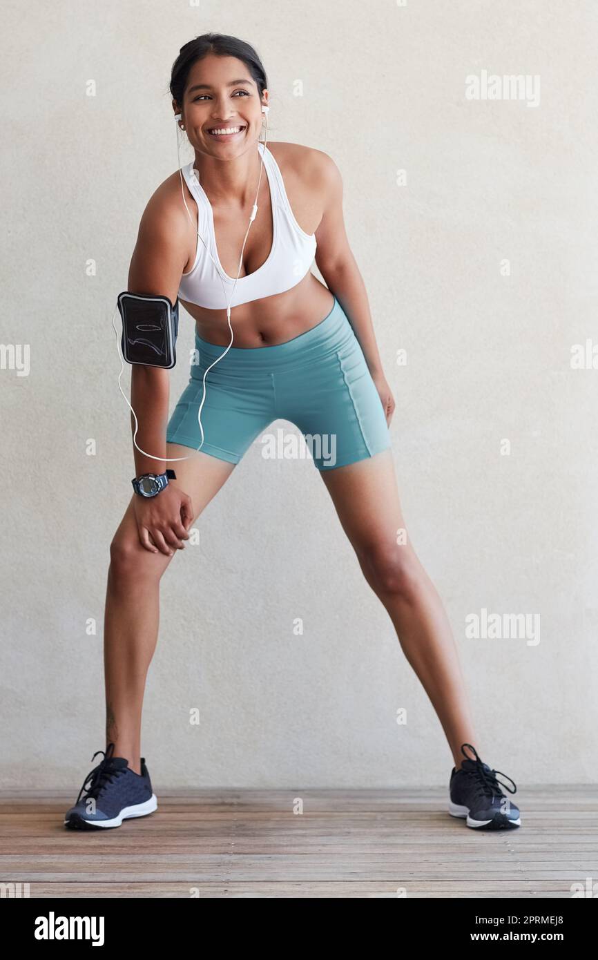Work out because it makes you happy. a sporty young woman working out at home. Stock Photo