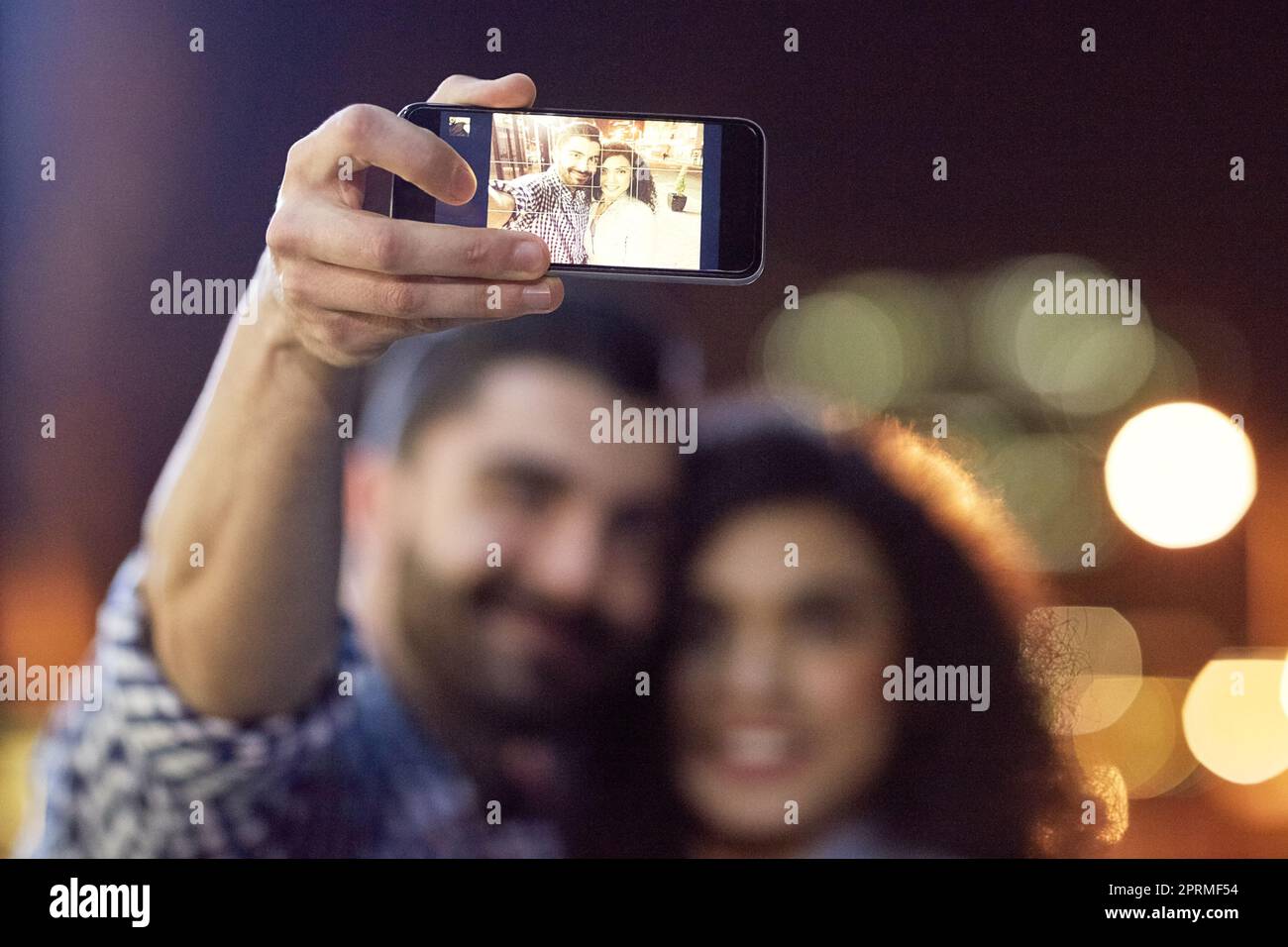 Making it a night to remember. an affectionate young couple taking a selfie while out on a date in the city. Stock Photo