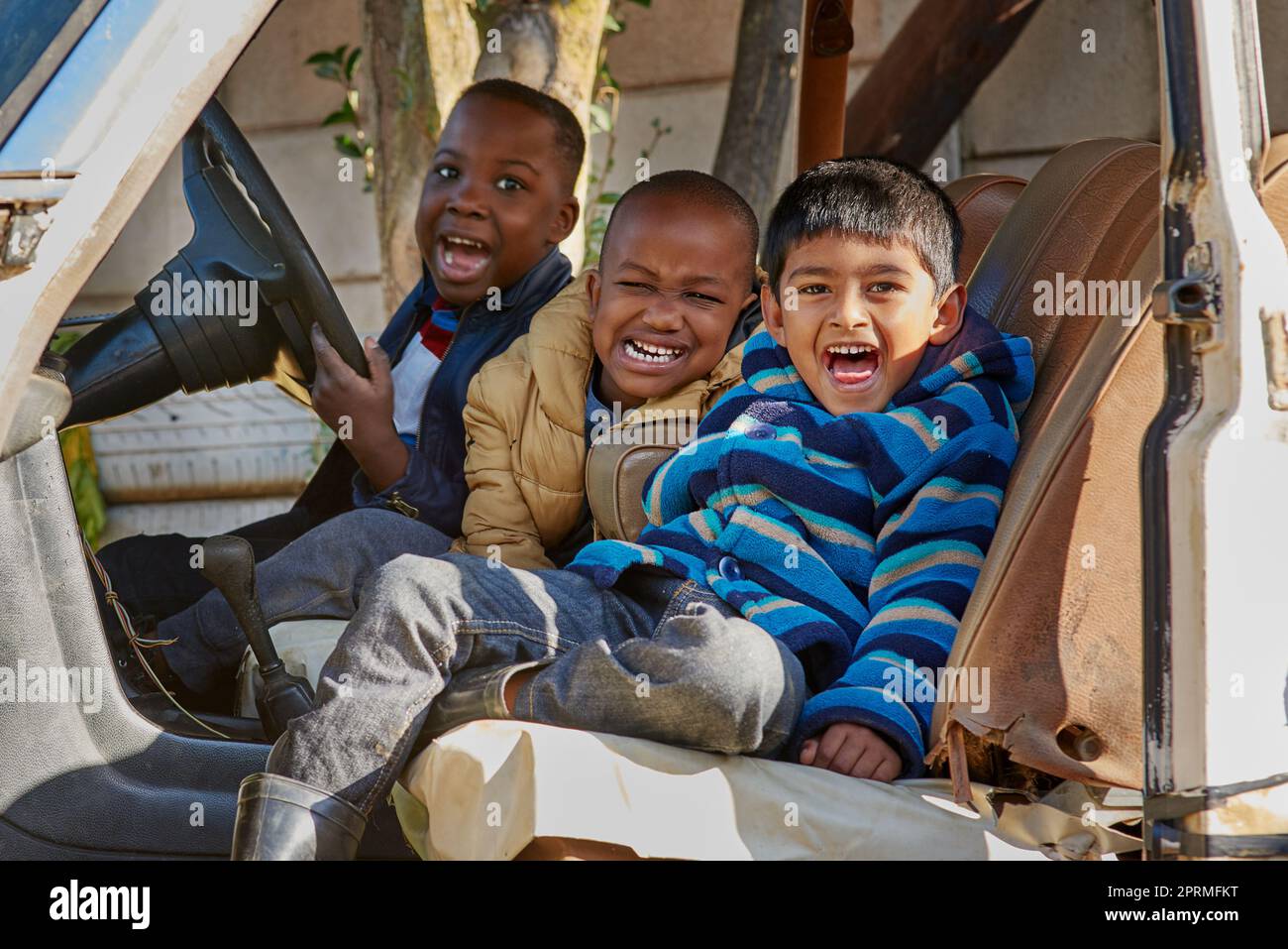 Theyre just being silly. Portrait of a group of little boys having fun while sitting in a car. Stock Photo