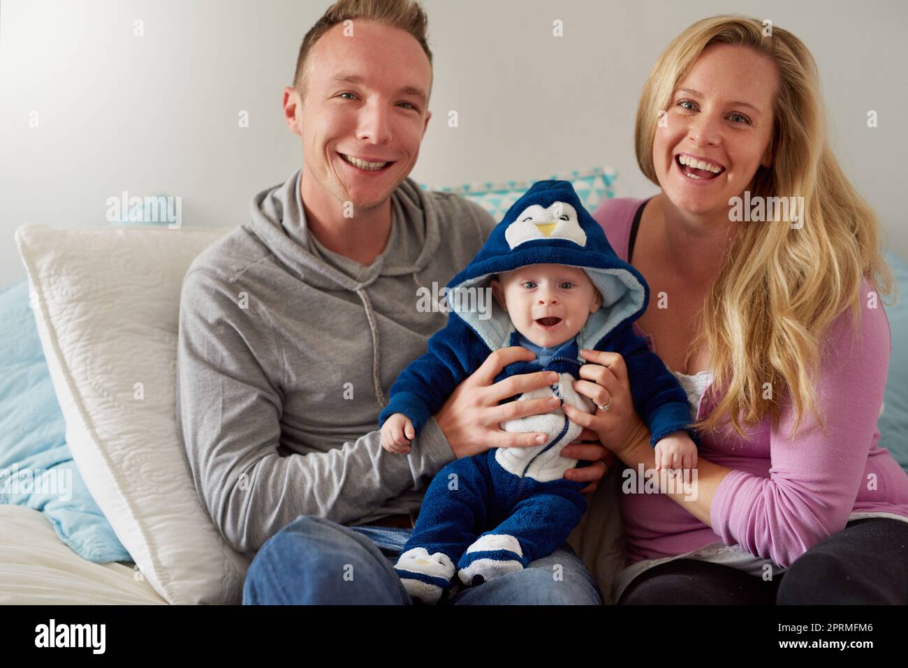 Parenthood has been bliss with this sweet little one. Portrait of a happy family spending quality time together at home. Stock Photo
