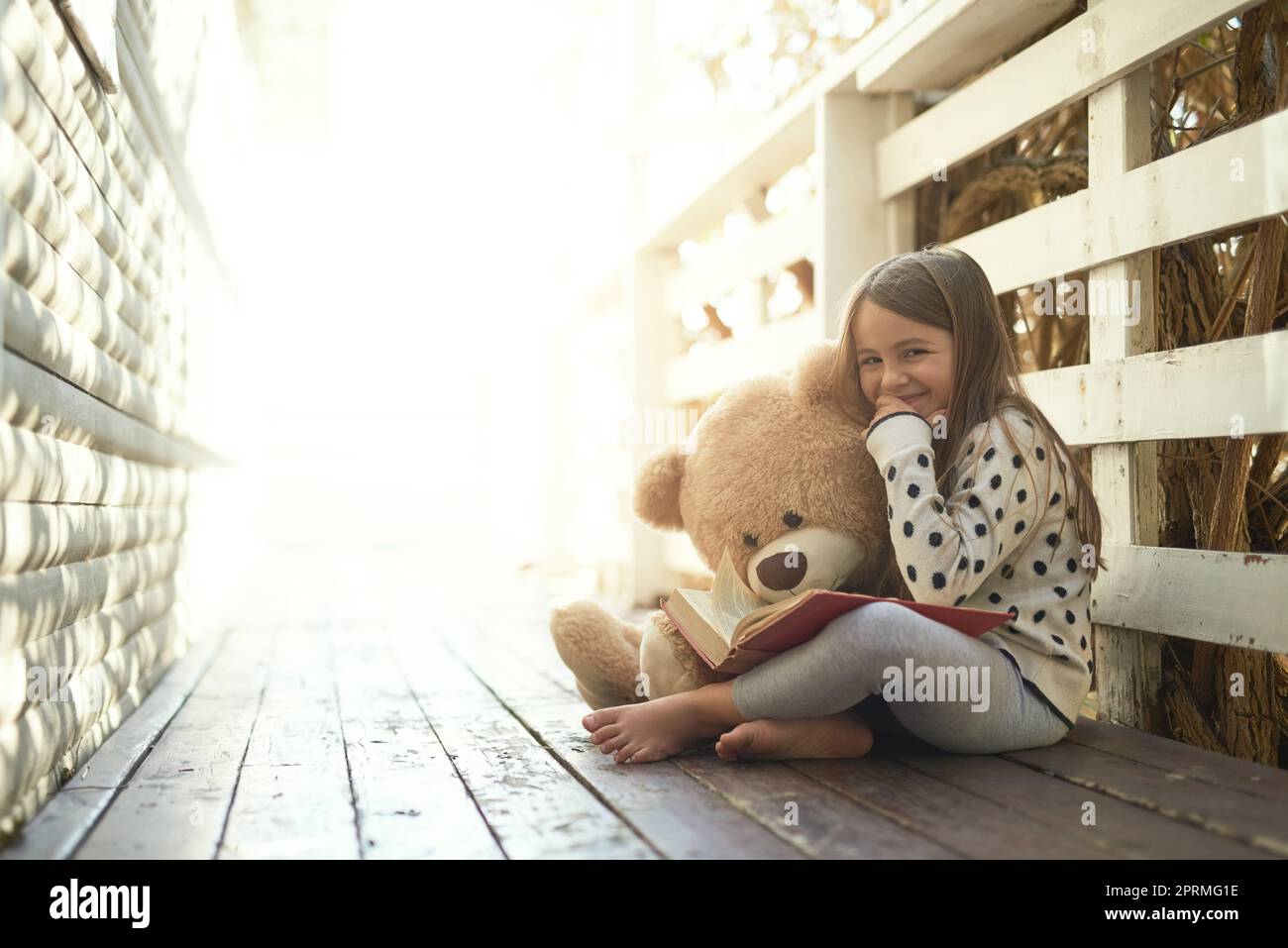 The sunshine days of childhood. Portrait of a little girl reading a