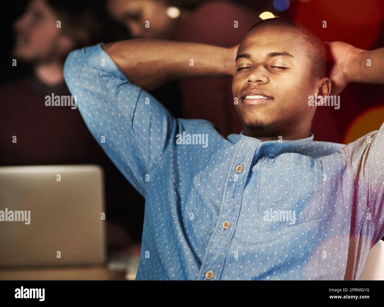 Hes got that deadline beat. a handsome young man looking relaxed while working late in the office. Stock Photo