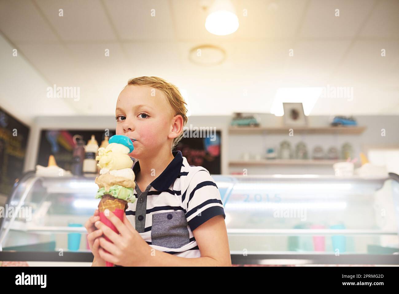 Ive got all my favourite flavours. Portrait of a young boy enjoying an ice cream cone Stock