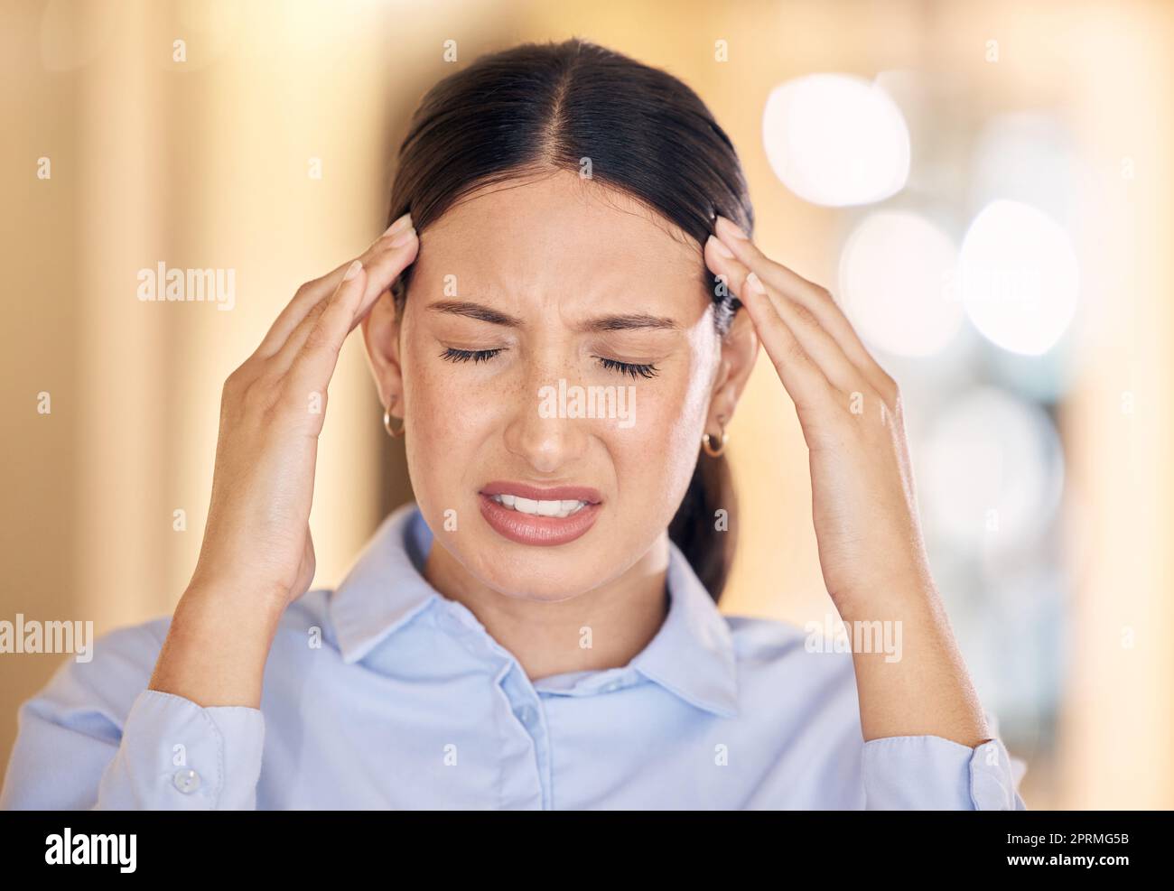 Stress, burnout and headache business woman working with mental health, depression and anxiety in office. Corporate female employee or worker with a migraine and is depressed and frustrated. Stock Photo