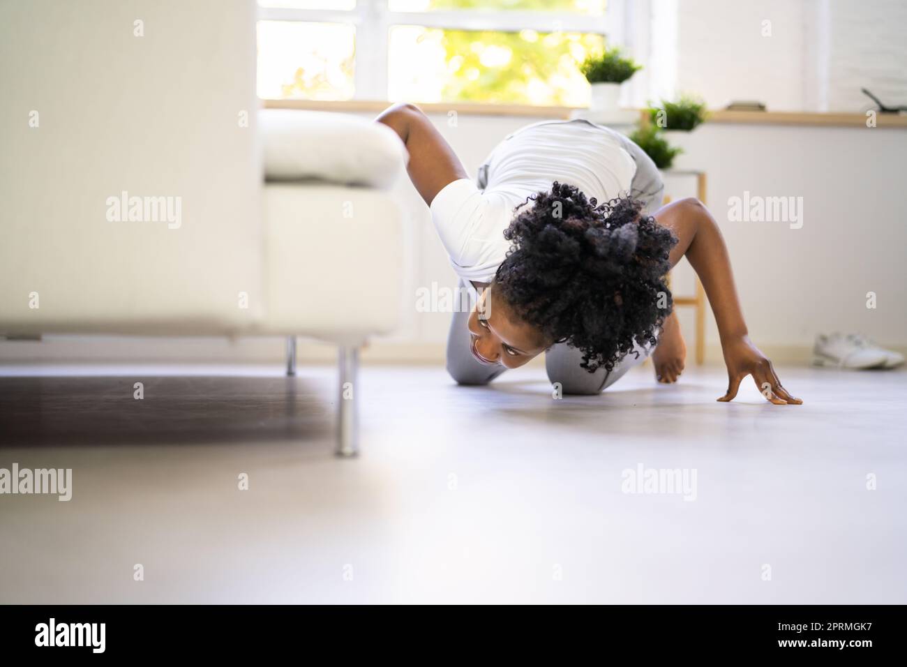 African Woman Lost Key Or Phone. Searching For Something Stock Photo