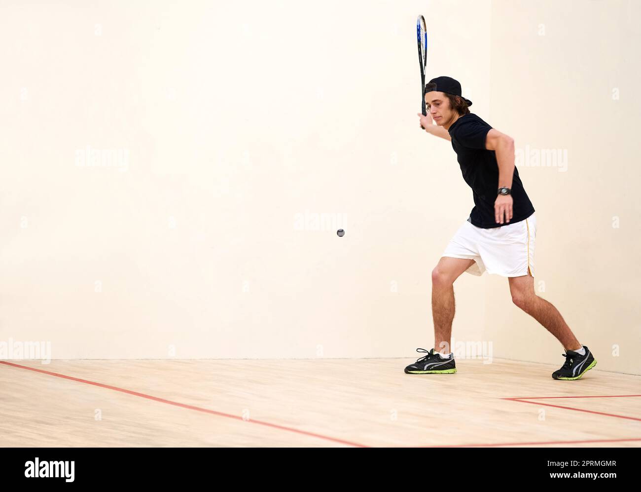 Squash is a sport that requires skill and speed. a young man playing