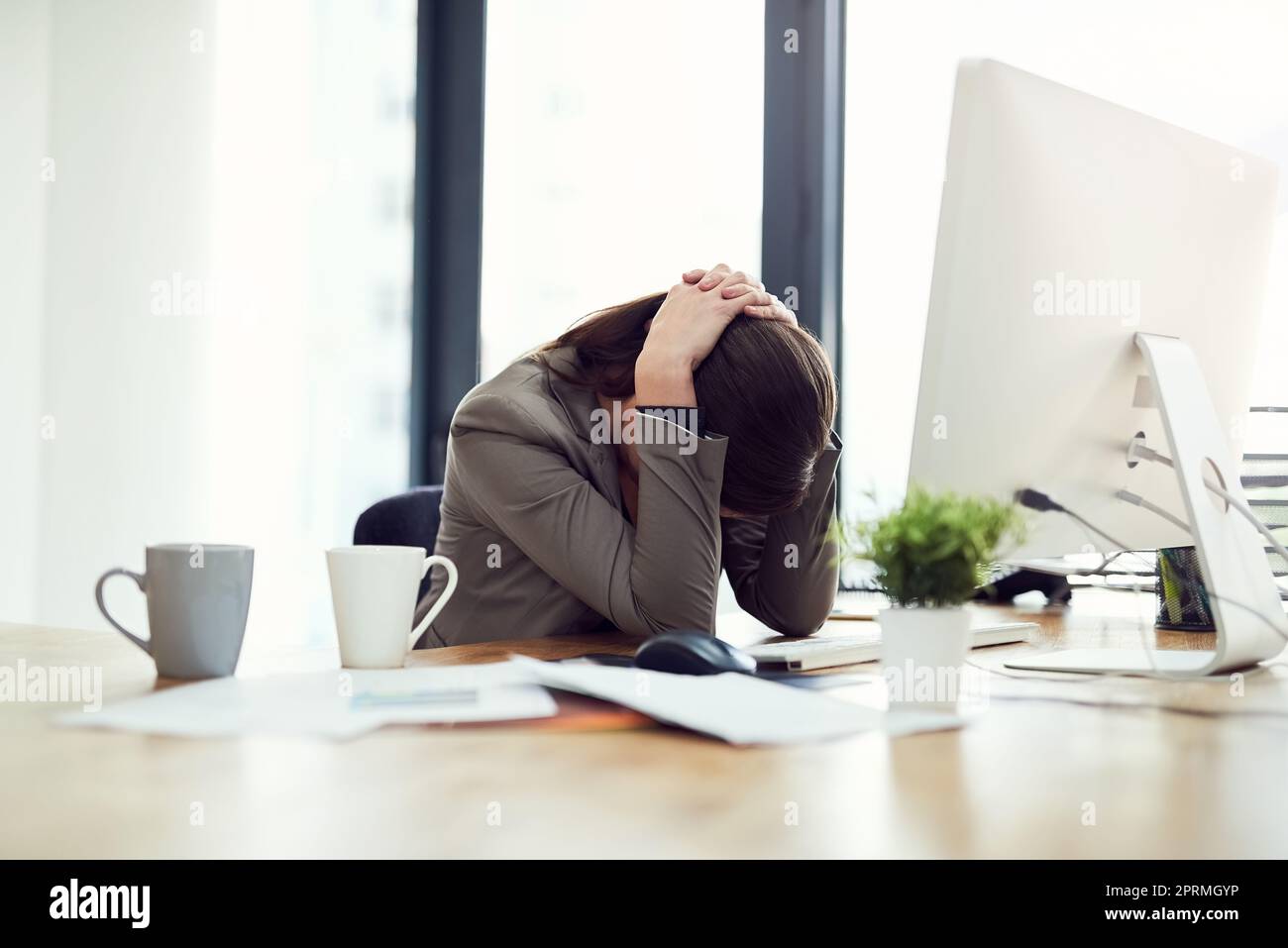 Shes been facing too many challenges for the day. a young businesswoman looking stressed out while working in an office. Stock Photo