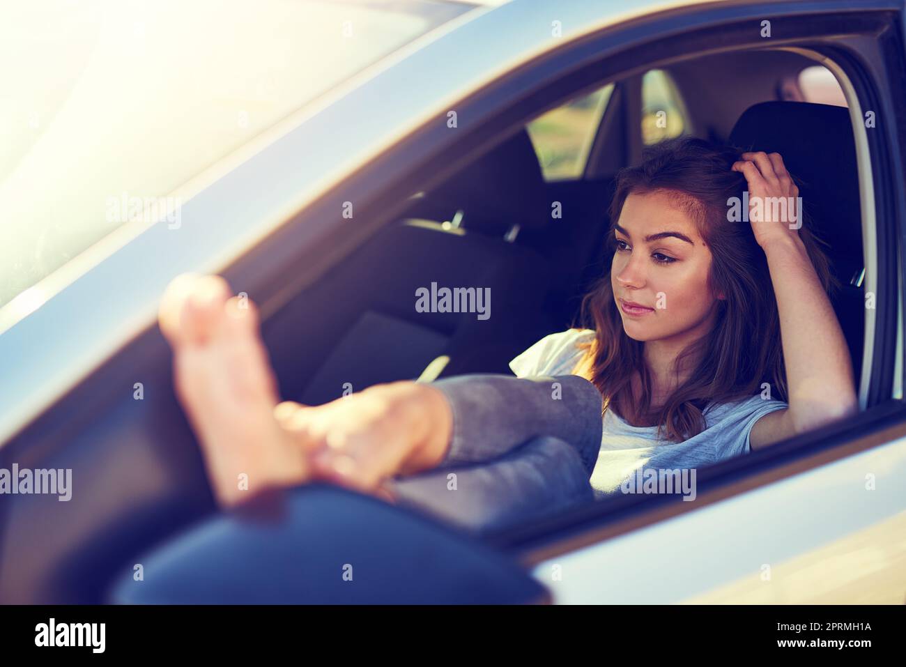 Road tripping is all about freedom. a young woman sitting in her car Stock Photo Alamy