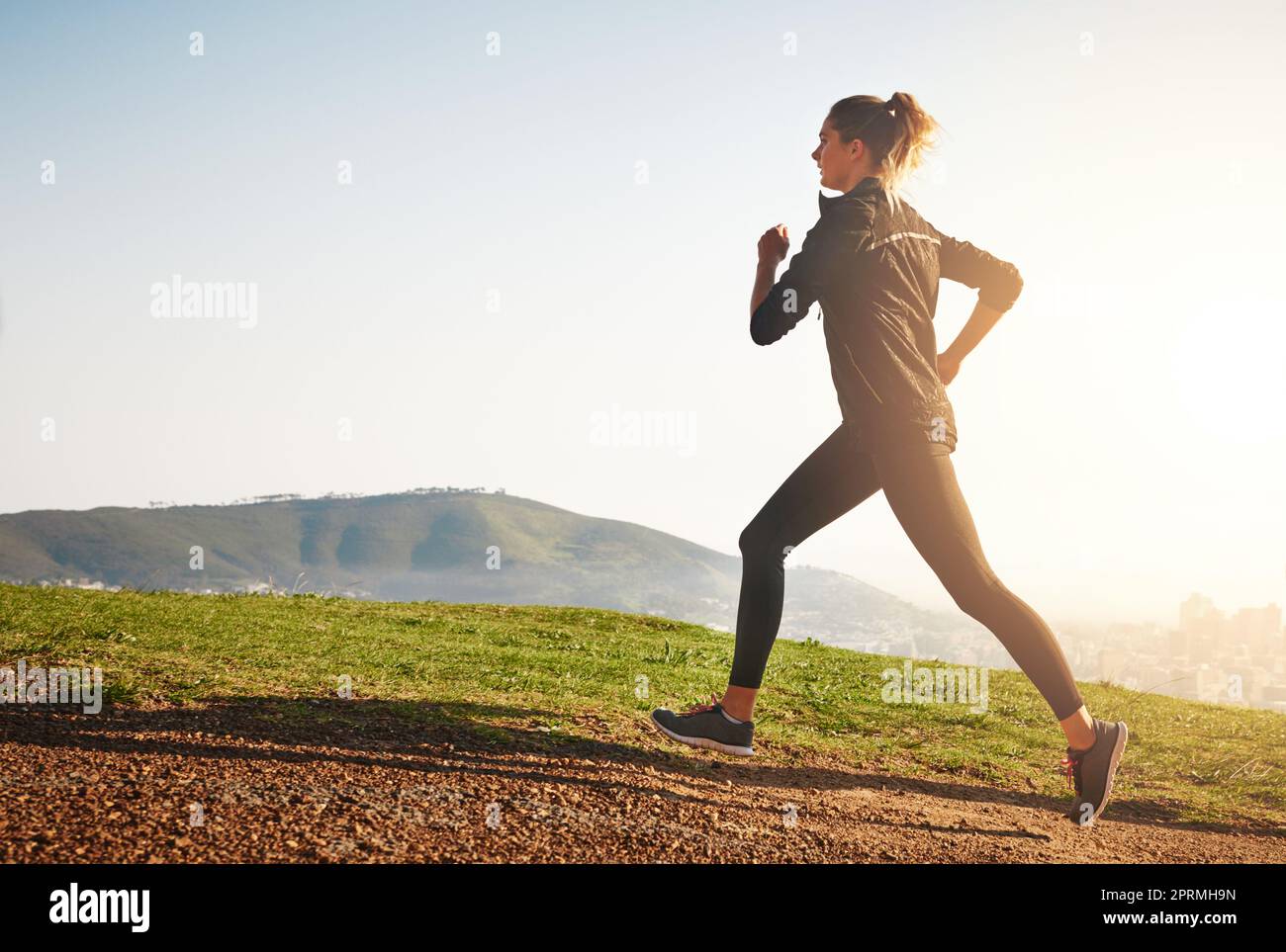 Young woman jogging alone in countryside stock photo