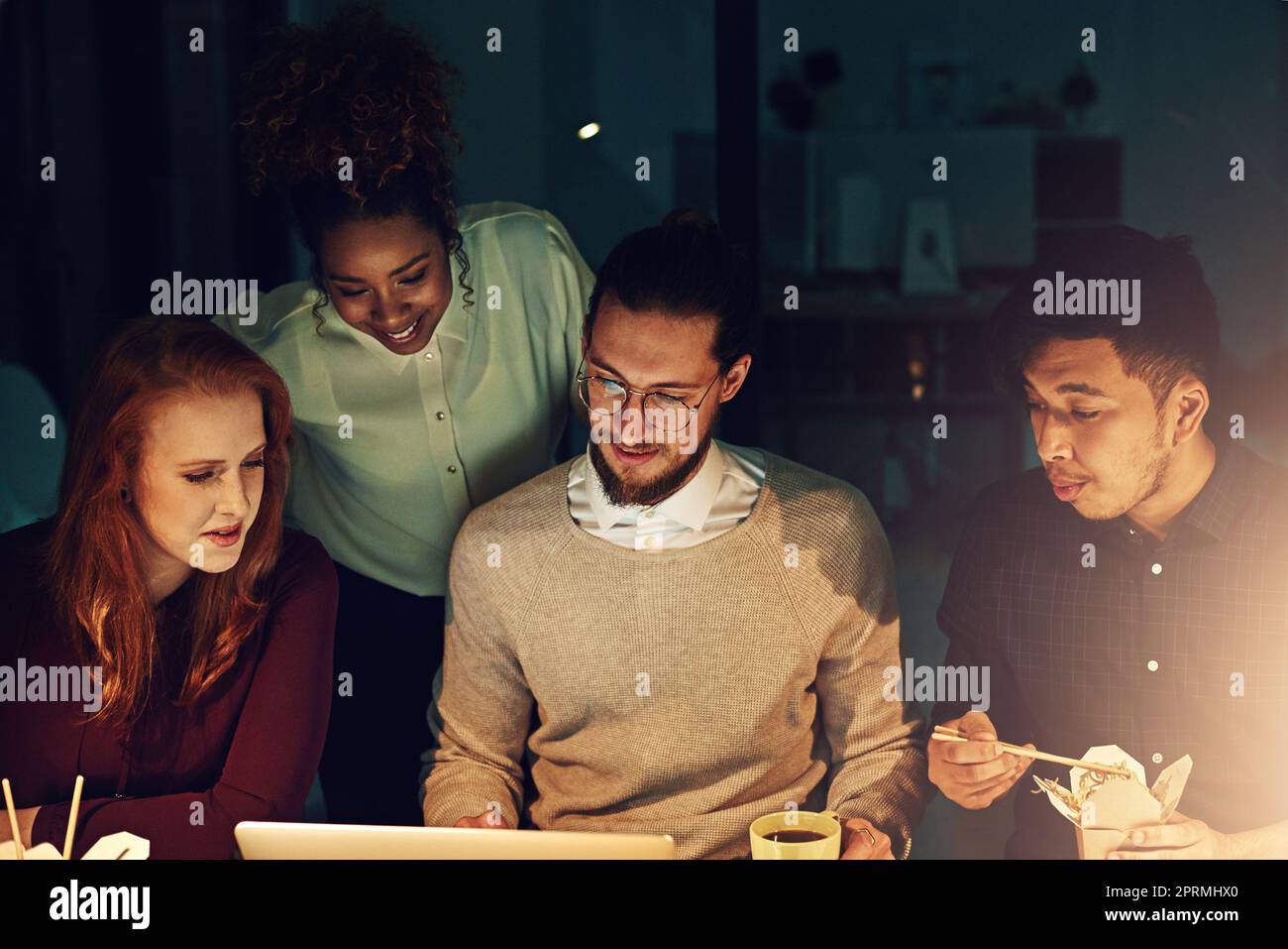 https://c8.alamy.com/comp/2PRMHX0/getting-things-done-on-time-no-matter-the-time-a-business-team-using-a-laptop-together-on-a-night-shift-at-work-2PRMHX0.jpg