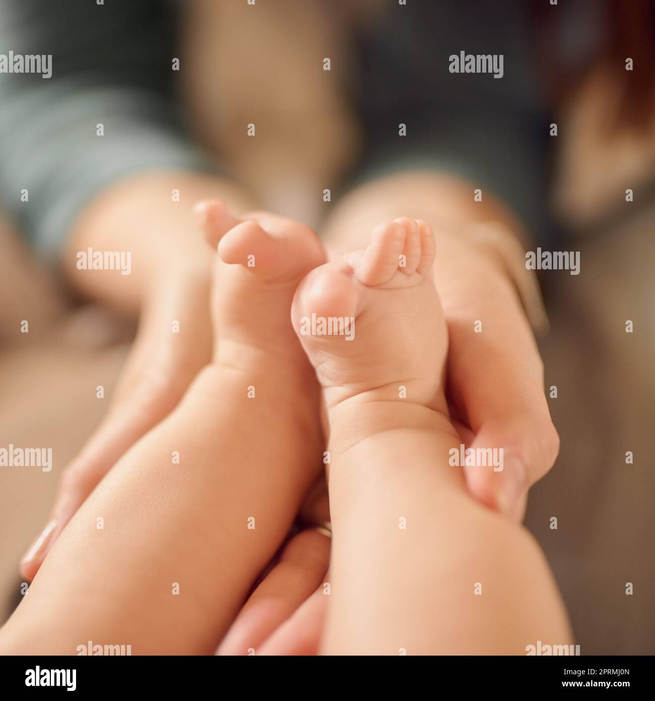 Big stories start with little chapters. an unidentifiable mother holding her babys feet. Stock Photo