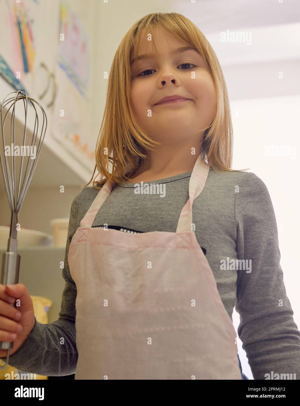 Where theres a whisk, theres a way. Portrait of a little girl holding a