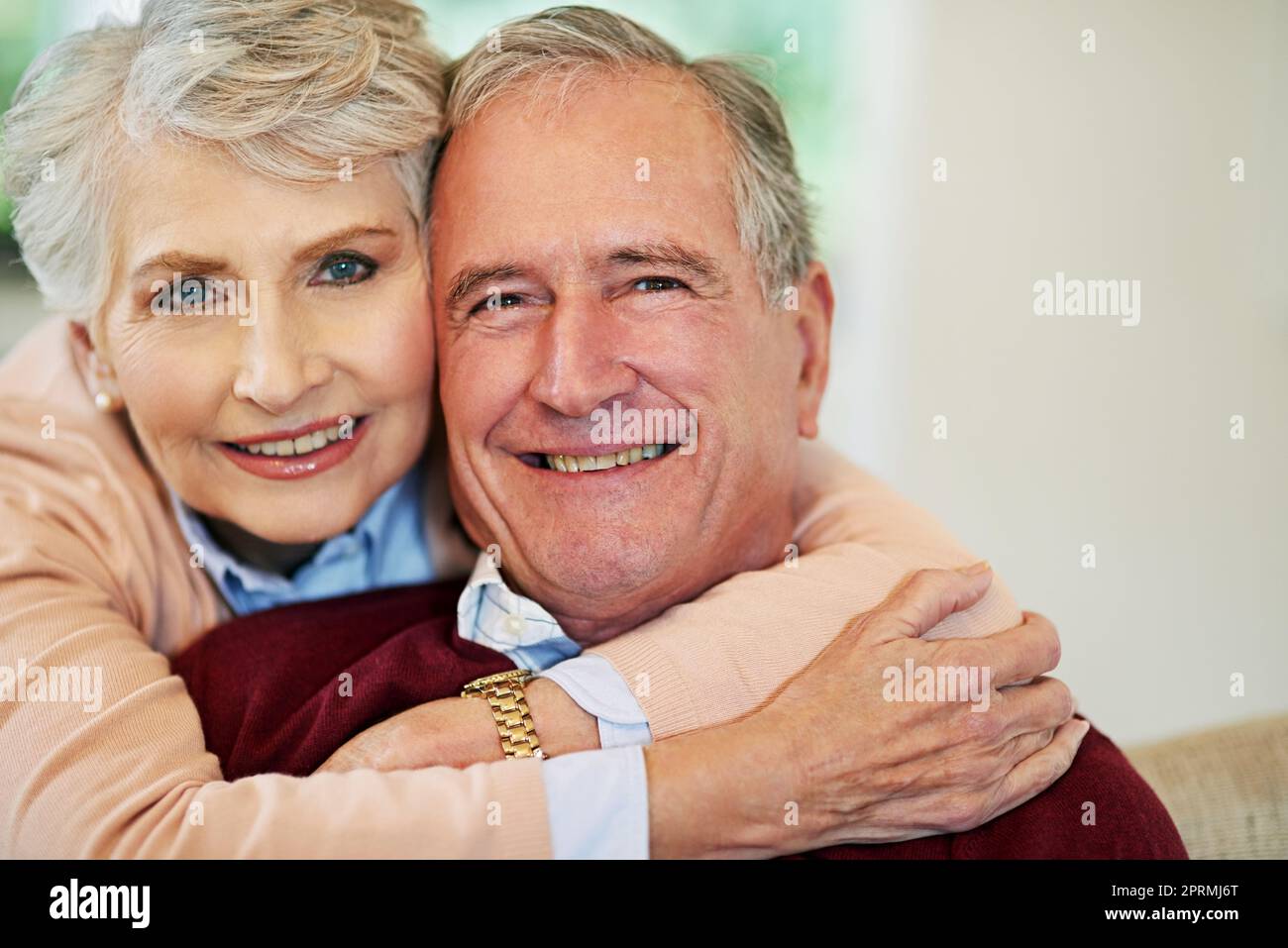 Love puts joy in the heart. a senior woman embracing her husband from behind. Stock Photo