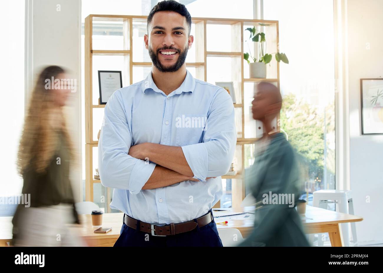 Portrait, business man and working in busy office building or corporate room or company with a smile. Happy, worker or employee, ceo or leader or manager at work planning, strategy or innovation. Stock Photo