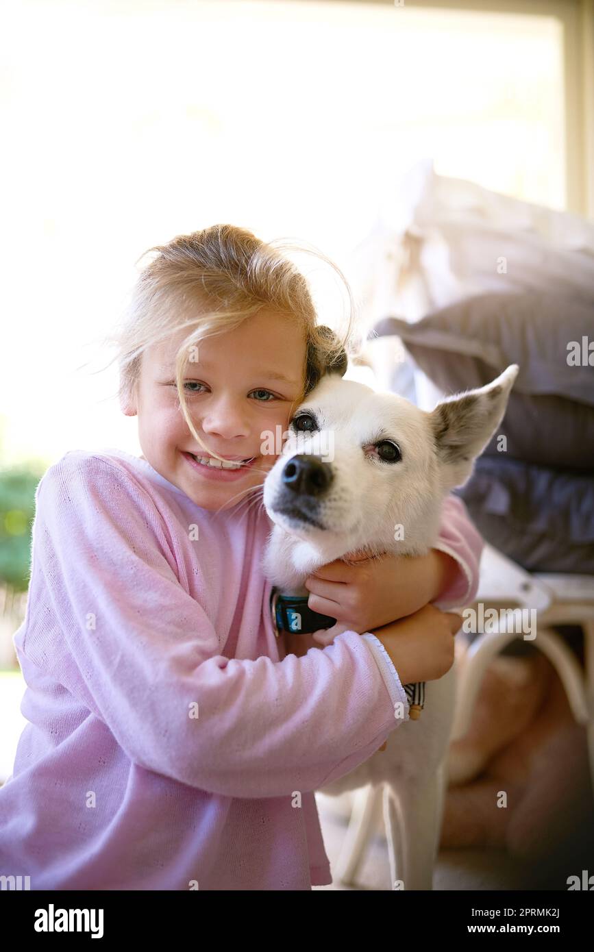 Hes my best friend. Portrait of a little girl embracing her dog. Stock Photo