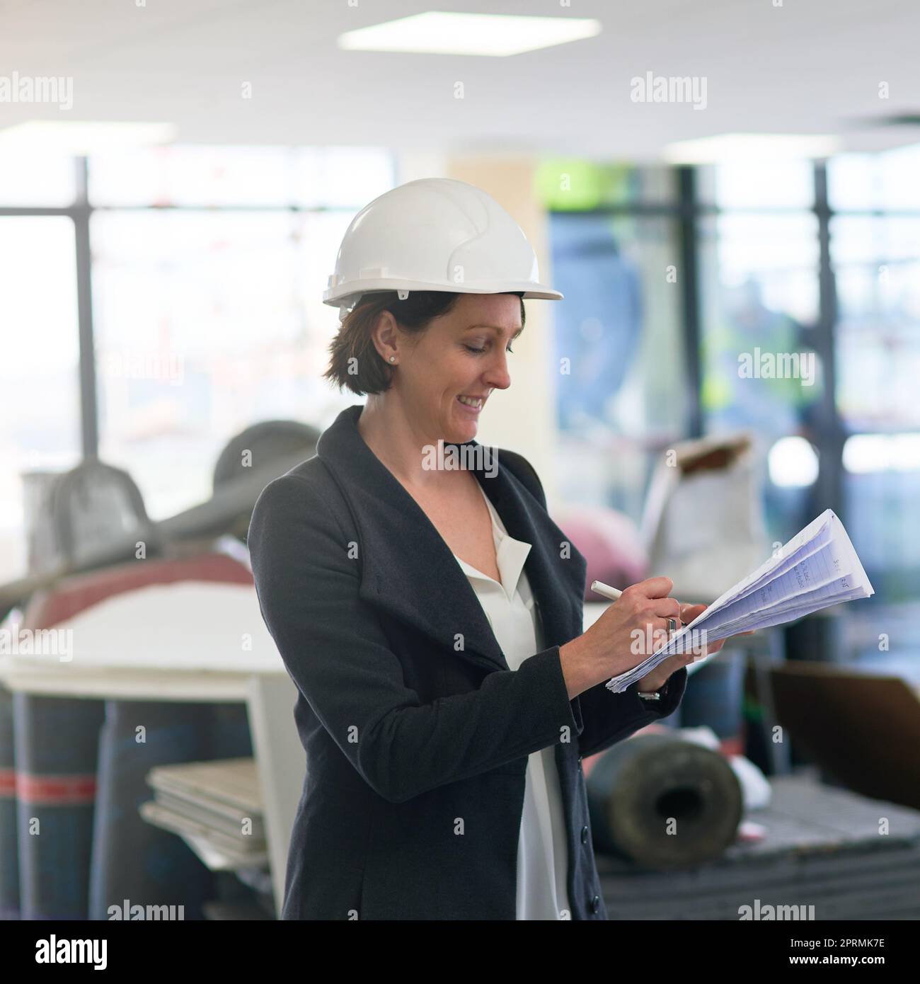 I love it when a plan comes together. a female construction manager on site wearing a hardhat. Stock Photo