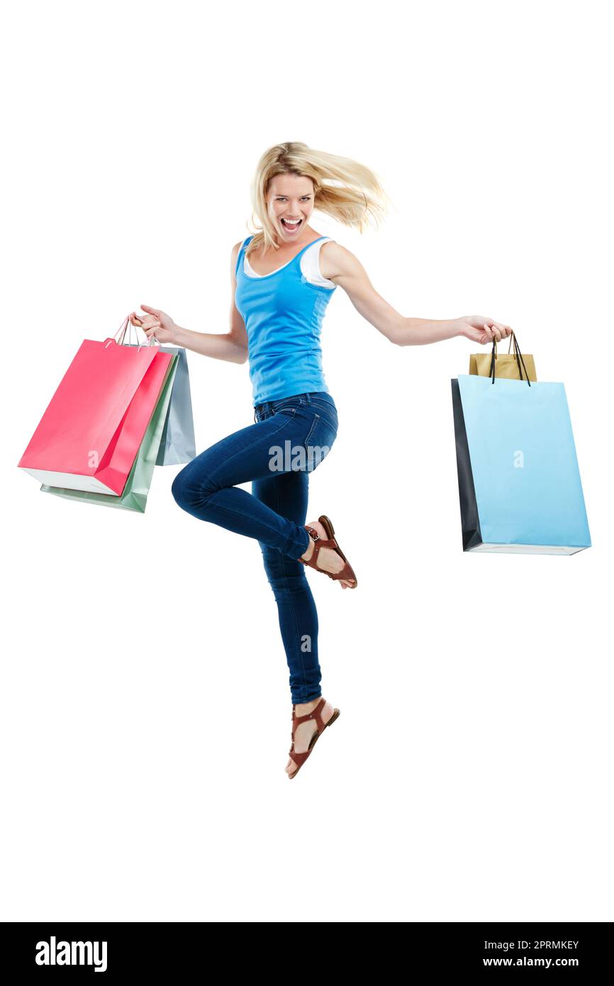 Shopping is my cardio. Studio shot of an attractive young woman holding shopping bags. Stock Photo