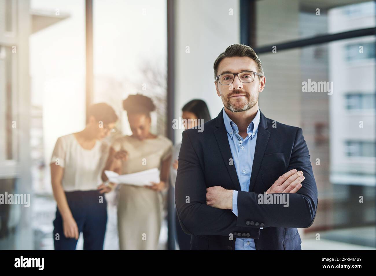 We deliver maximum professionalism for maximum productivity. a group of businesspeople standing in the office. Stock Photo