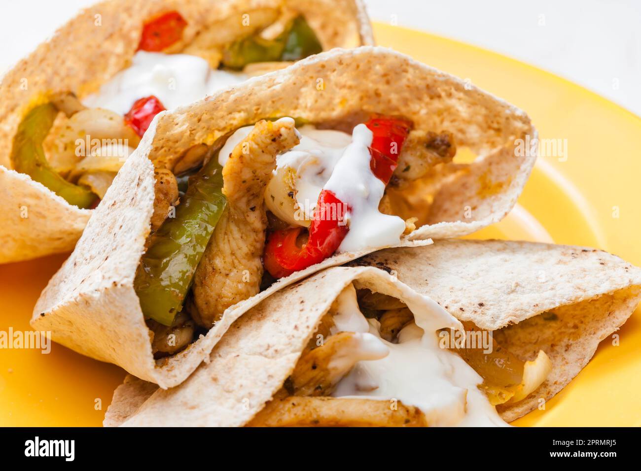 wholewheat  pitta bread filled with grilled chicken meat, jalapenos and red pepper Stock Photo