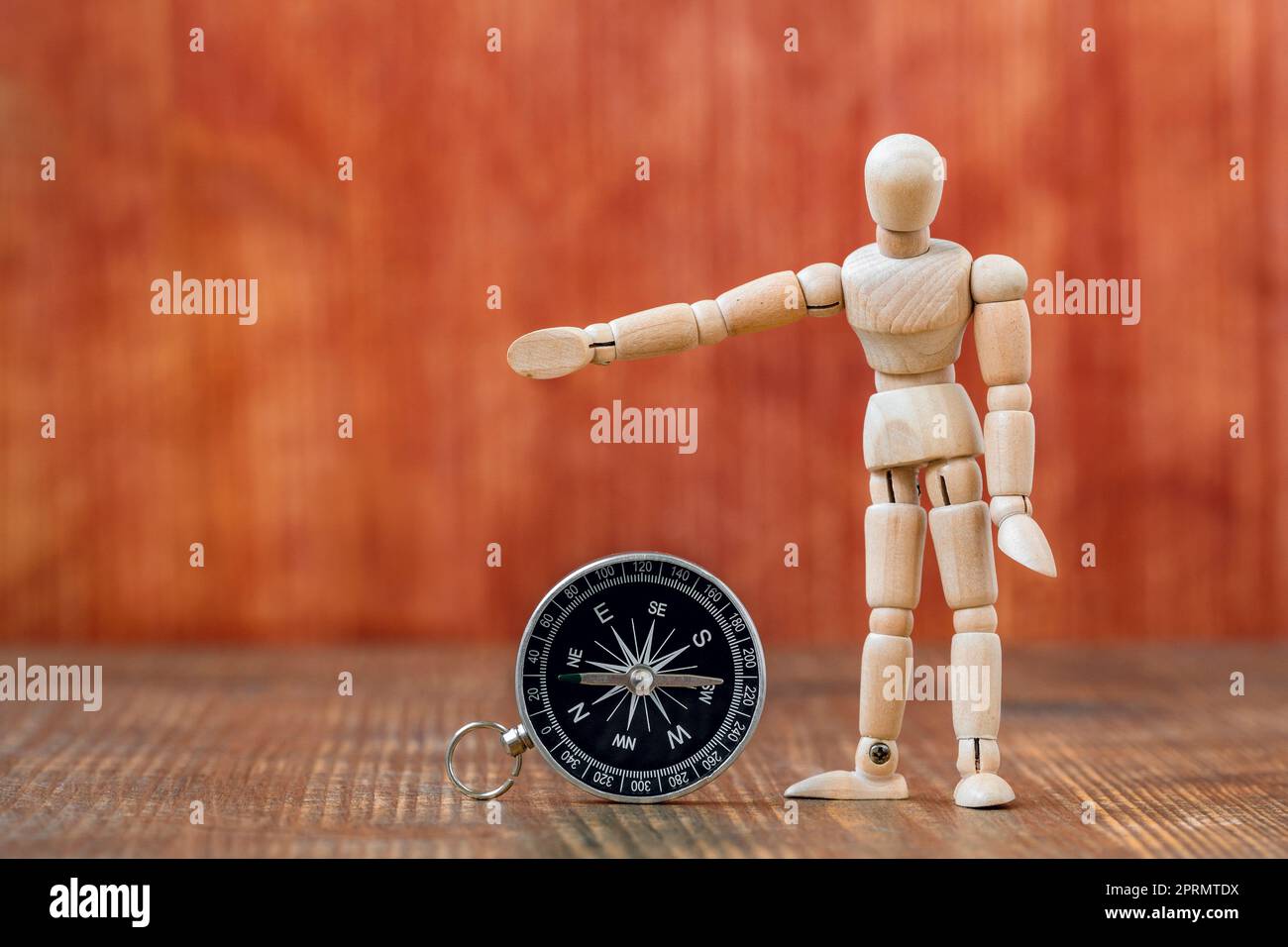Dummy with compass showing right direction to go Stock Photo Alamy