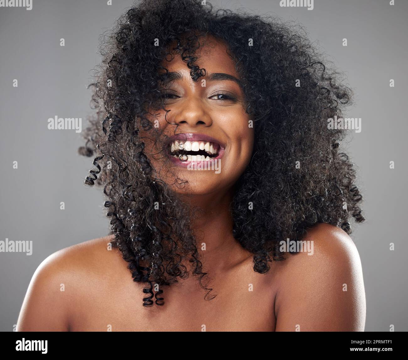 Face, hair care and beauty smile of black woman on gray studio