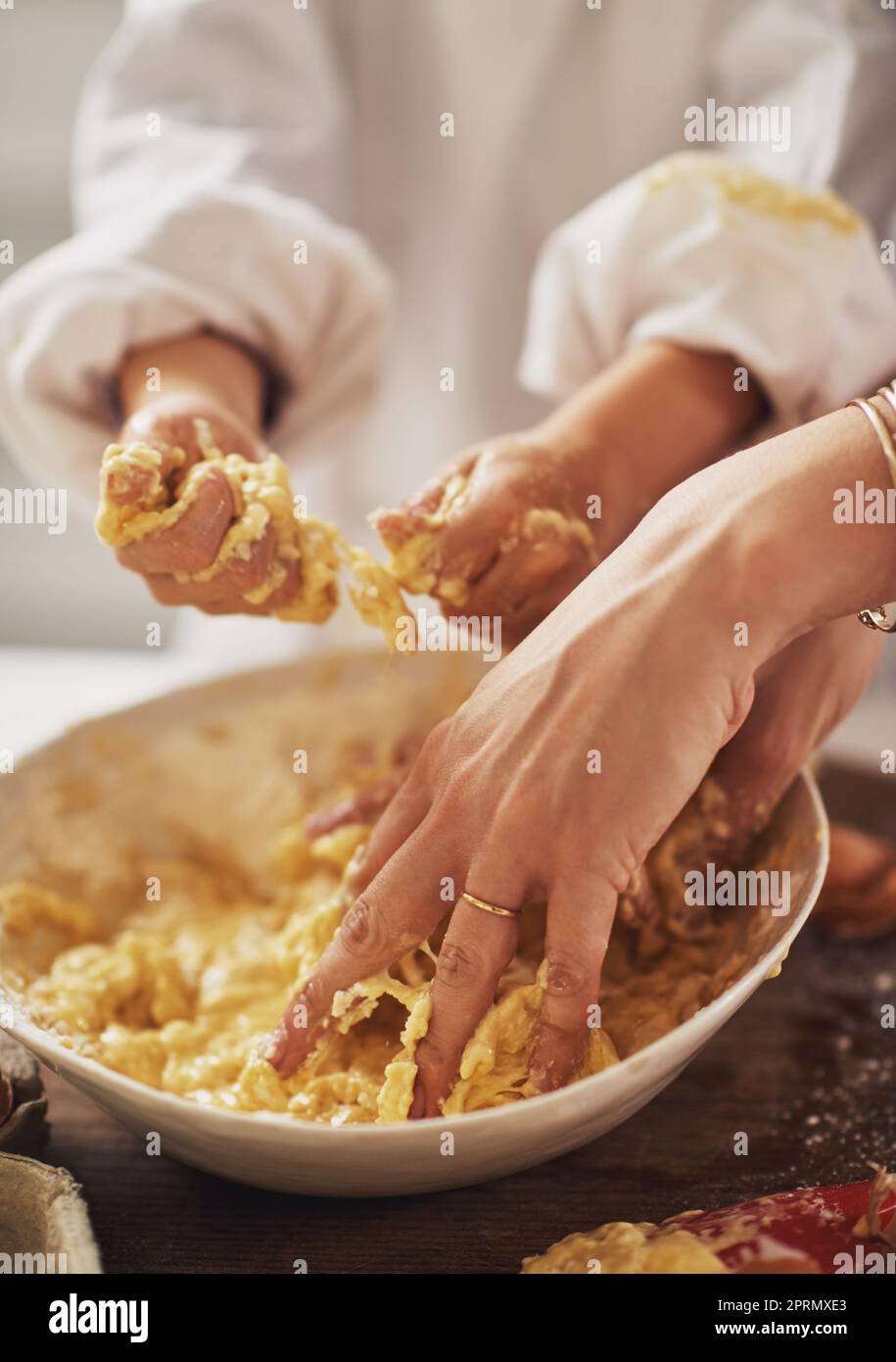 Its messy but fun. a mother and her son baking in the kitchen. Stock Photo