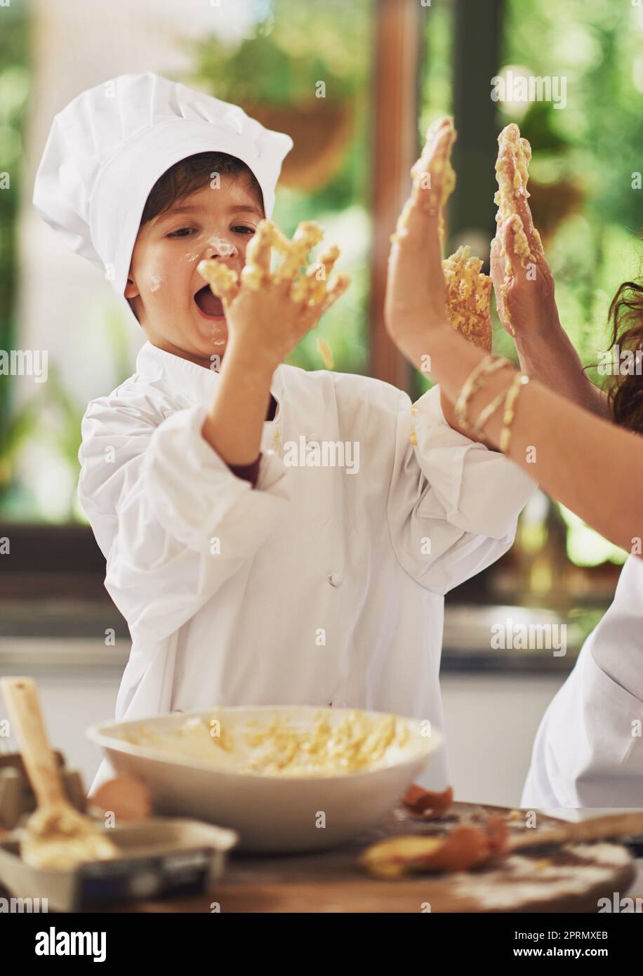 Joy in the kitchen. a mother and her young son baking together in the kitchen. Stock Photo