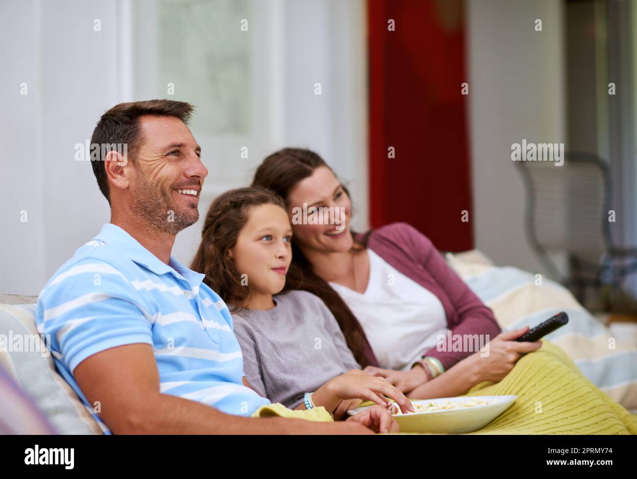 Its movie night. a family watching a movie on the sofa. Stock Photo