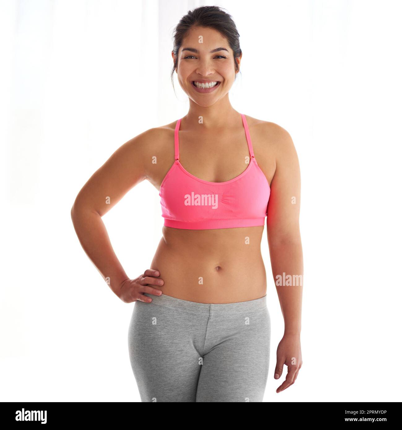 Being healthy and fit is a lifestyle. a young woman in exercise clothing against a white background. Stock Photo