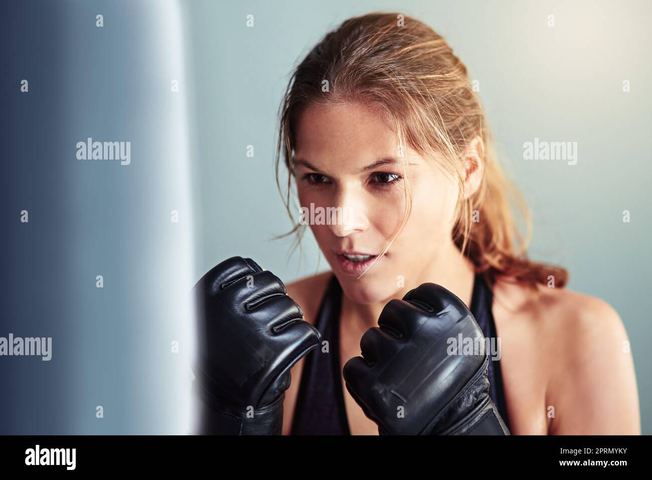 Throwing some punches. a female boxer working out with a punching bag Stock Photo Alamy