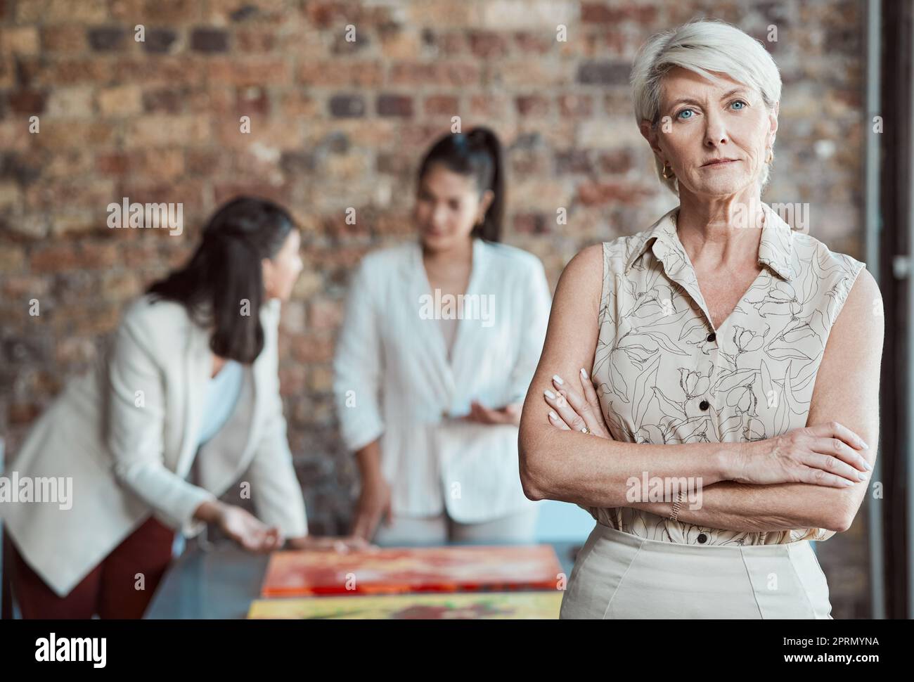 Elderly woman, art gallery manager and exhibition room working talking. Interior design business, review paintings and project teamwork. Serious buyer talking, museum collection and creative critic Stock Photo