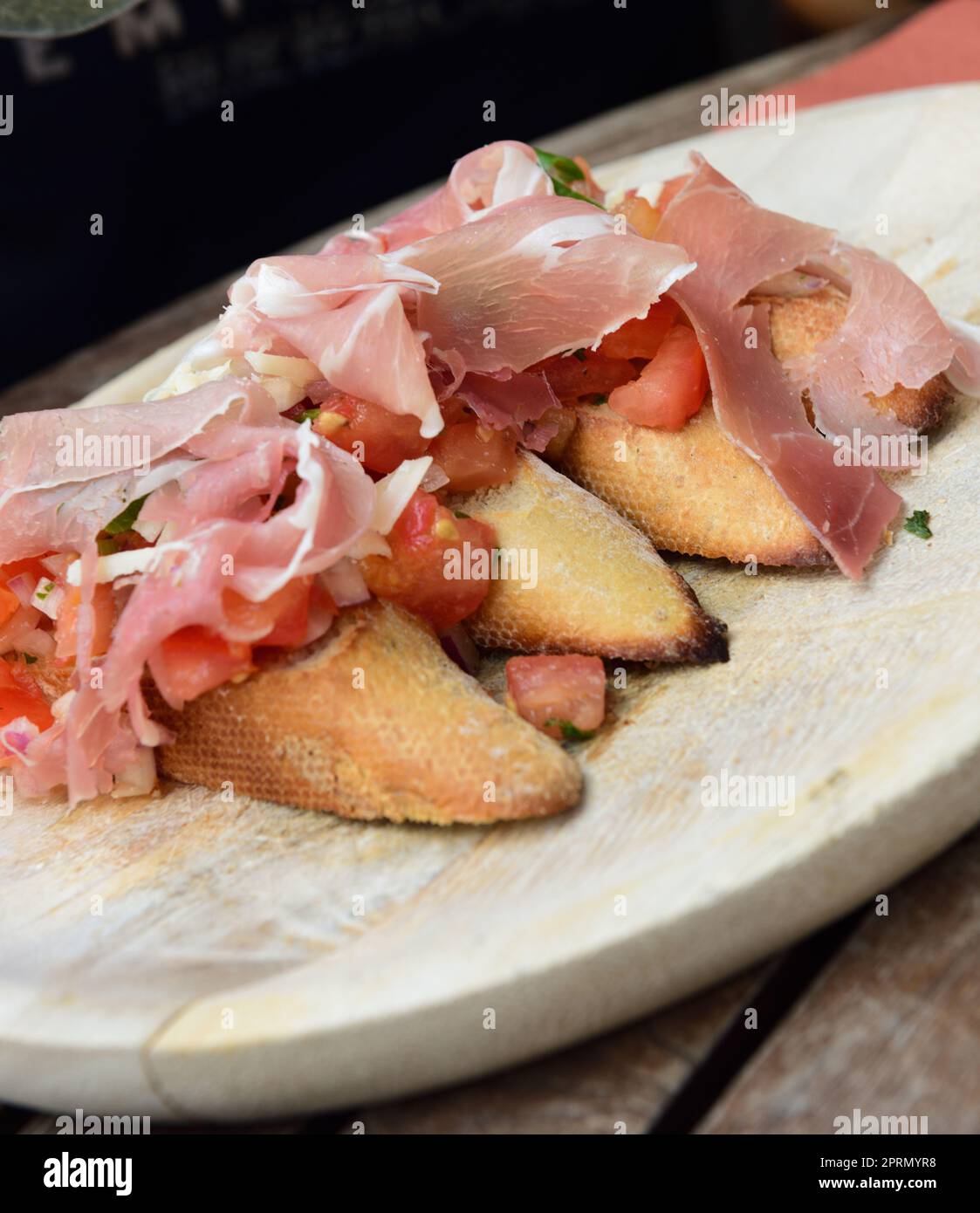 Bruschetta with tomatoes and garlic and ham Stock Photo