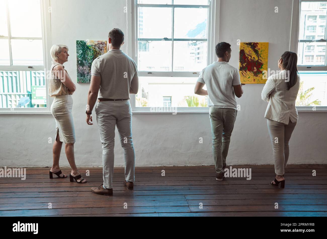 Art, painting and men and women at a gallery exhibition with paintings. Culture, creativity and sales, museum visitors standing at a canvas. Beauty, presentation and discussion on creative artwork. Stock Photo