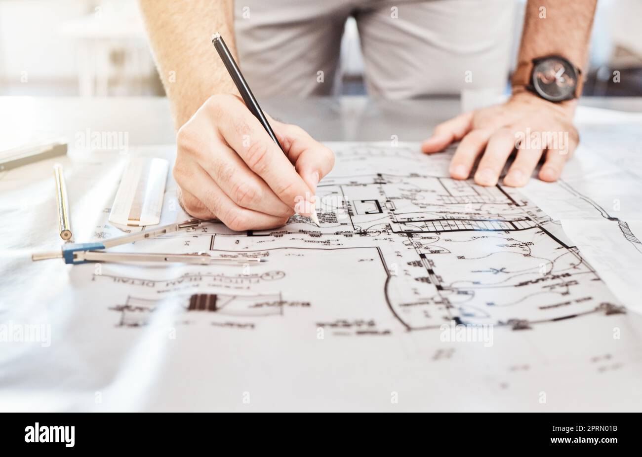 Drawing construction on blueprint, planning architecture design on paper and writing notes on building documents on table in work office. Designer, architect and builder with strategy for renovation Stock Photo