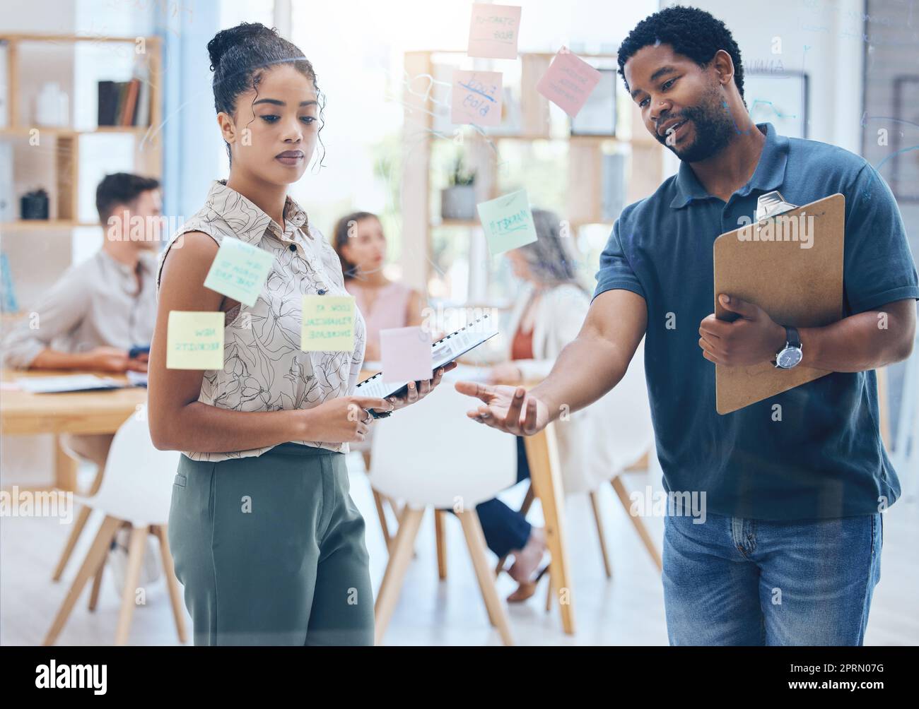 Post it, marketing schedule and teamwork collaboration in creative office with target audience research, kpi data and information. Black woman and man planning business growth with brand vision idea Stock Photo