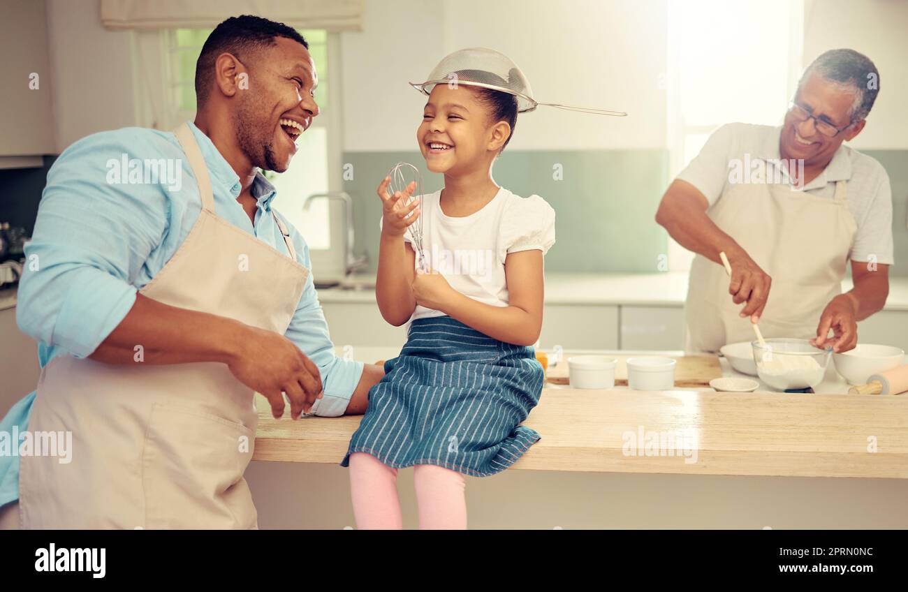 Girl, father and funny and crazy kitchen entertainment with child to bond with parent in home. Silly, cute and happy family relationship with innocent and goofy fun while cooking together. Stock Photo