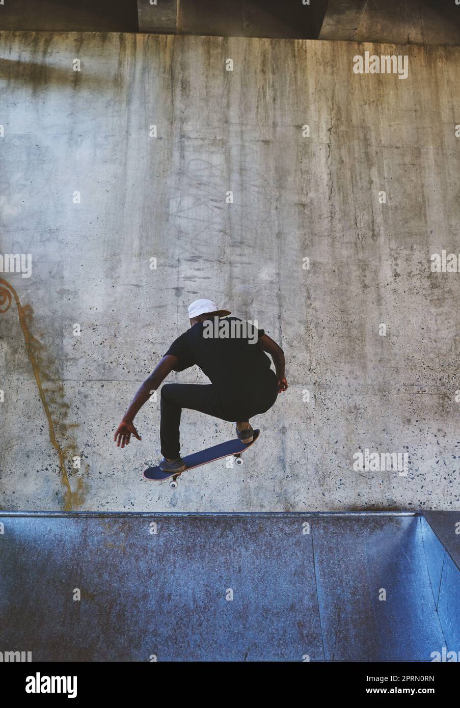 Life is better when you shred. a young man doing tricks on his skateboard at the skatepark. Stock Photo